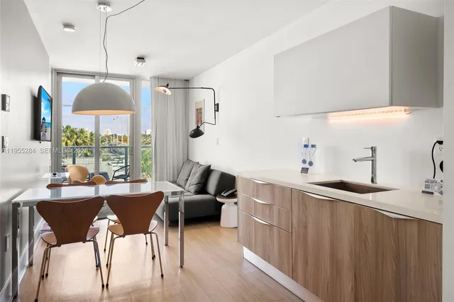 a kitchen with stainless steel appliances kitchen island granite countertop a sink a stove and a refrigerator