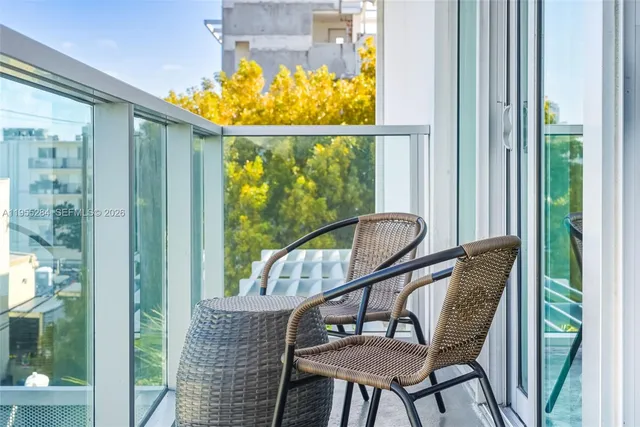 a view of a balcony with a table and chairs