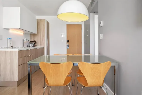 a dining room with furniture and a chandelier
