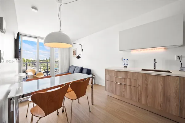 a kitchen with stainless steel appliances granite countertop a sink a stove and a wooden floor