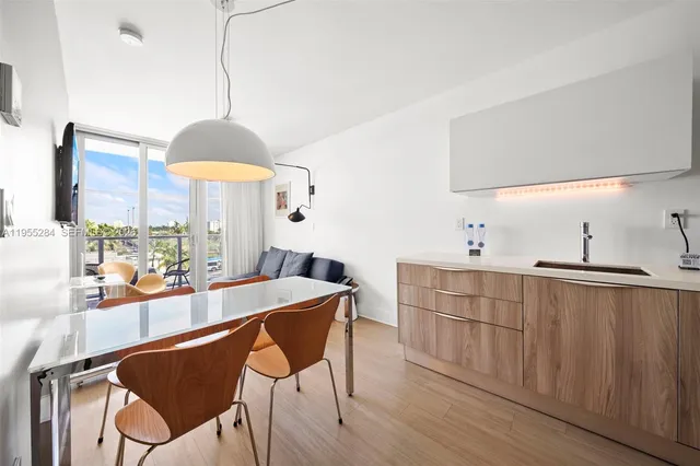 a kitchen with stainless steel appliances granite countertop a sink a stove and a wooden floor