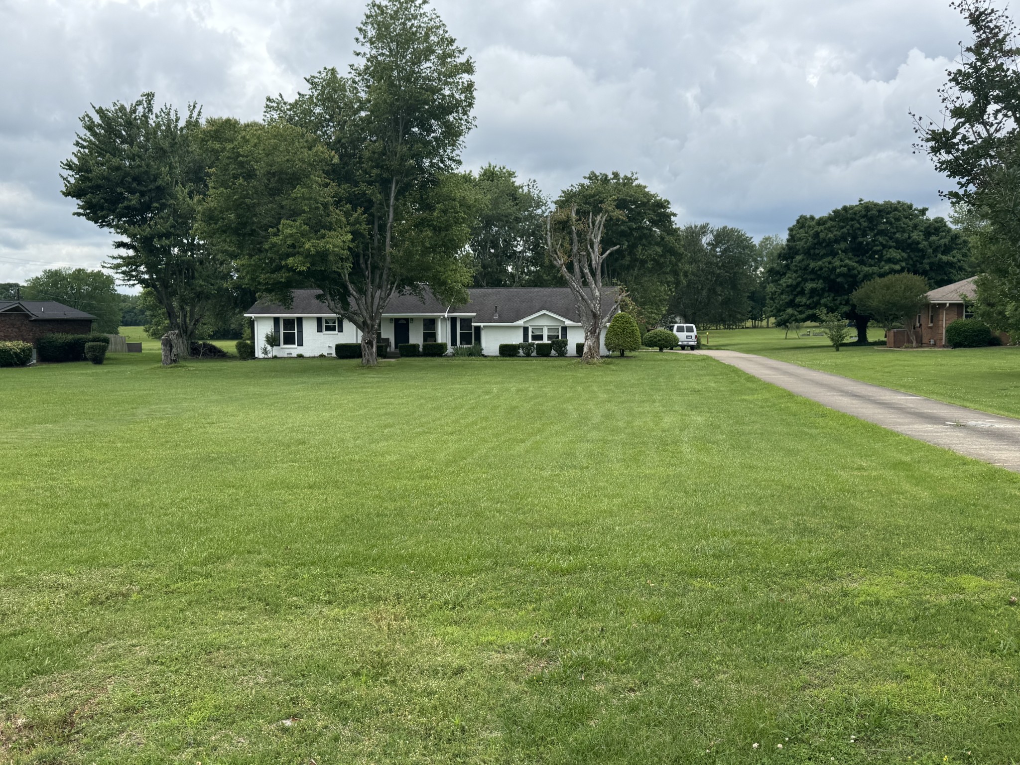7181 Bidwell Road Joelton, TN 37080 - Photo 11 of 33 a front view of a house with a yard and trees