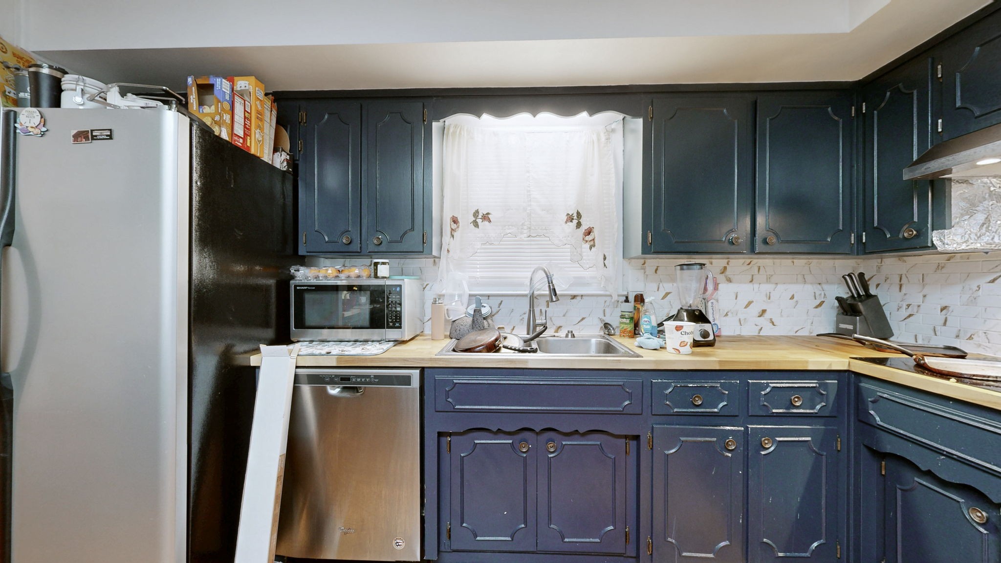 7181 Bidwell Road Joelton, TN 37080 - Photo 16 of 33 a kitchen with a sink a refrigerator and cabinets