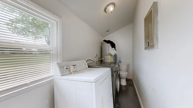 a view of storage and utility room with washer and dryer