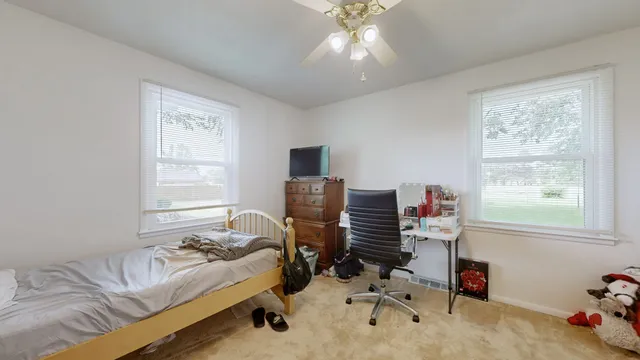 a bedroom with a workspace