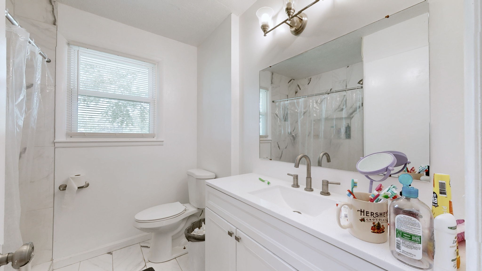 7181 Bidwell Road Joelton, TN 37080 - Photo 26 of 33 a bathroom with a sink a toilet and shower curtain
