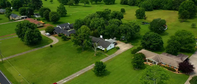 an aerial view of a house with a yard basket ball court and outdoor seating