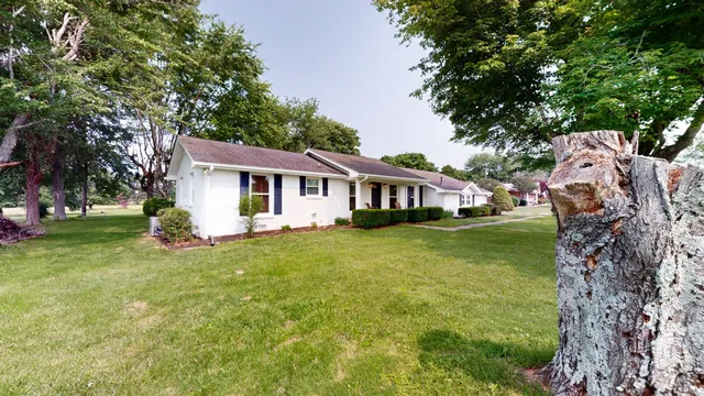 a front view of a house with a garden