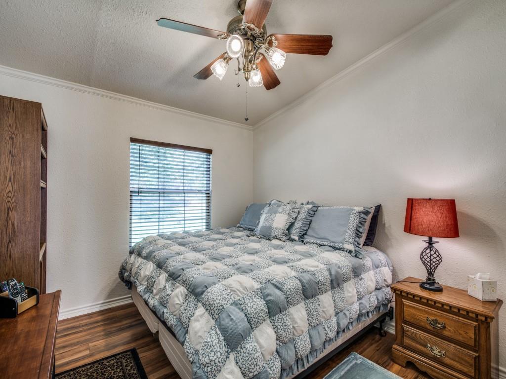 233 Esquire Estates Road Mabank, TX 75156 - Photo 18 of 34 a bedroom with a bed and a chandelier