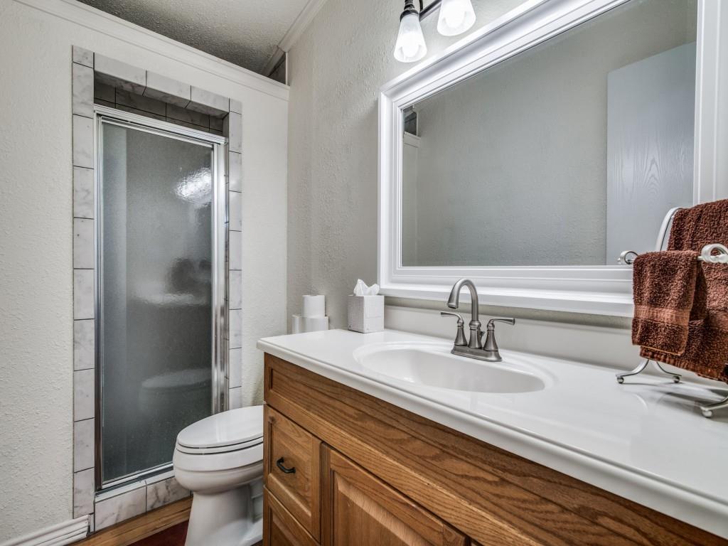 233 Esquire Estates Road Mabank, TX 75156 - Photo 19 of 34 a bathroom with a sink a toilet a mirror and shower