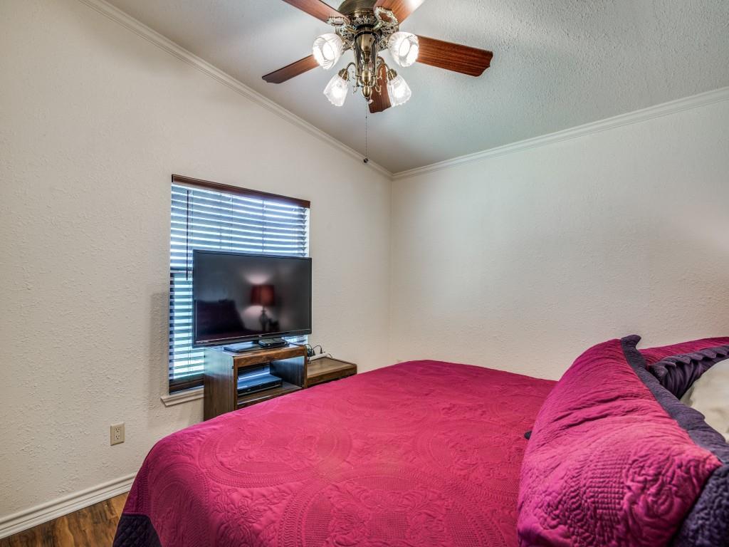 233 Esquire Estates Road Mabank, TX 75156 - Photo 20 of 34 a bedroom with a bed and a chandelier