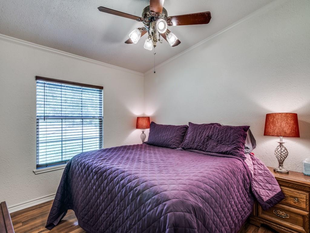 233 Esquire Estates Road Mabank, TX 75156 - Photo 21 of 34 a bedroom with a large bed and a chandelier