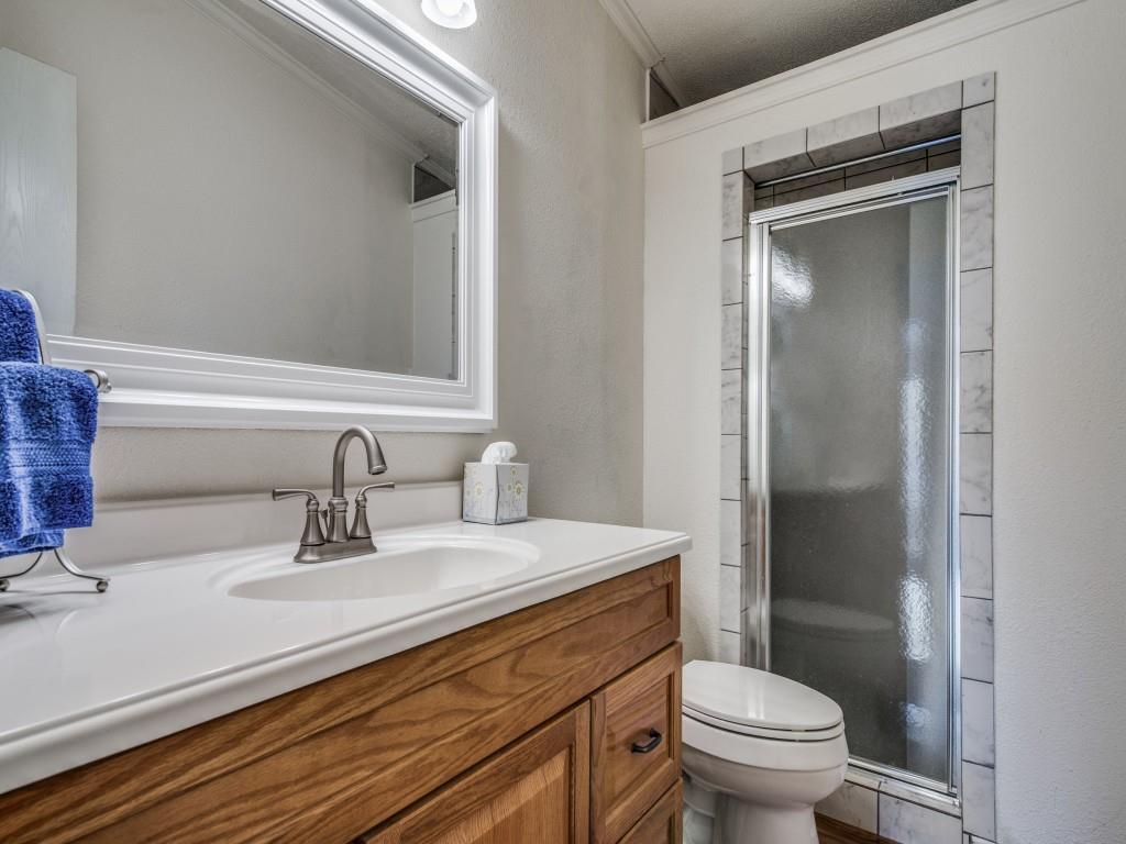 233 Esquire Estates Road Mabank, TX 75156 - Photo 22 of 34 a bathroom with a sink a toilet and shower