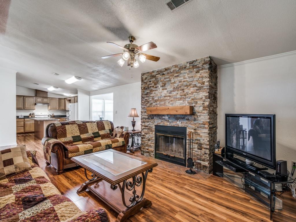 233 Esquire Estates Road Mabank, TX 75156 - Photo 7 of 34 a living room with furniture a flat screen tv and a fireplace