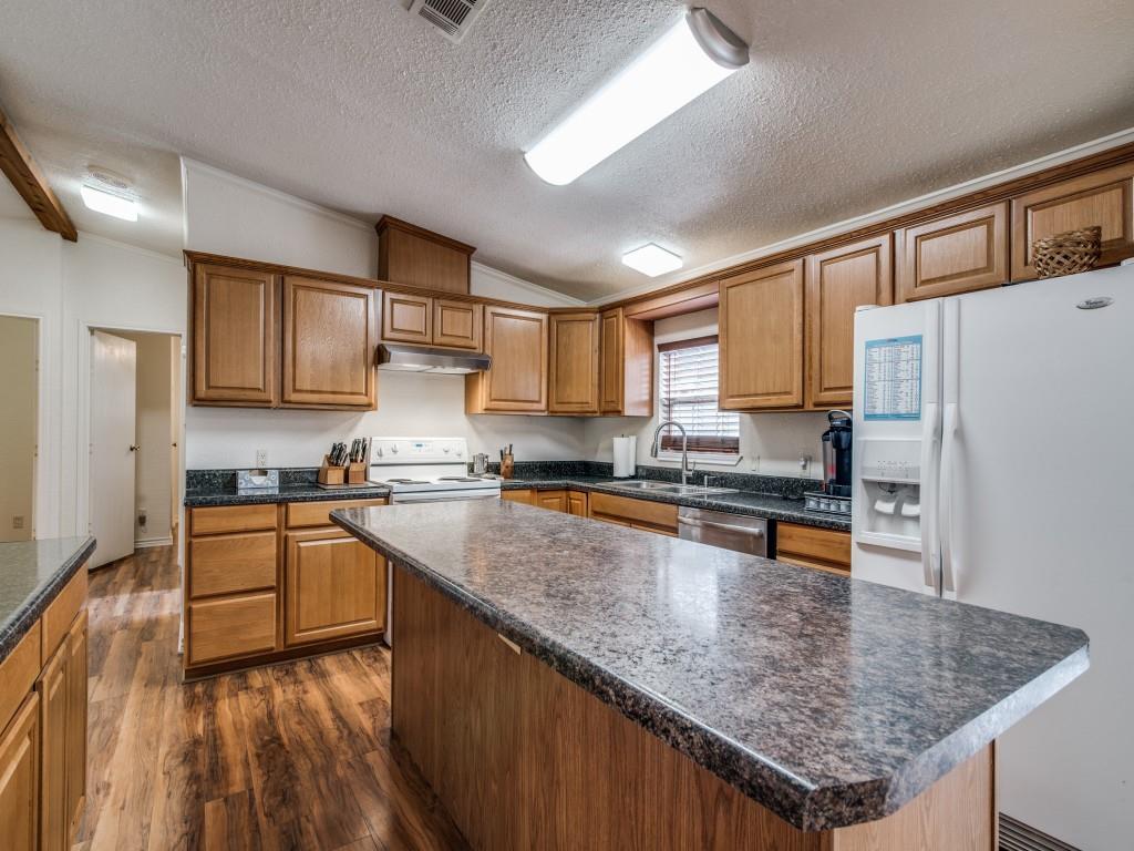 233 Esquire Estates Road Mabank, TX 75156 - Photo 9 of 34 a kitchen with stainless steel appliances granite countertop a stove refrigerator sink and cabinets