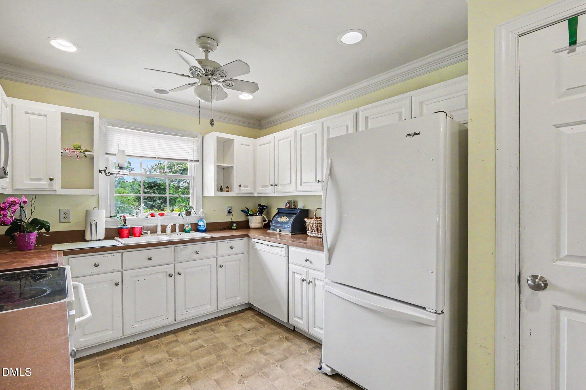 1750 Tom Oakley Road Timberlake, NC 27583 - Photo 12 of 31 a kitchen with a sink refrigerator and cabinets