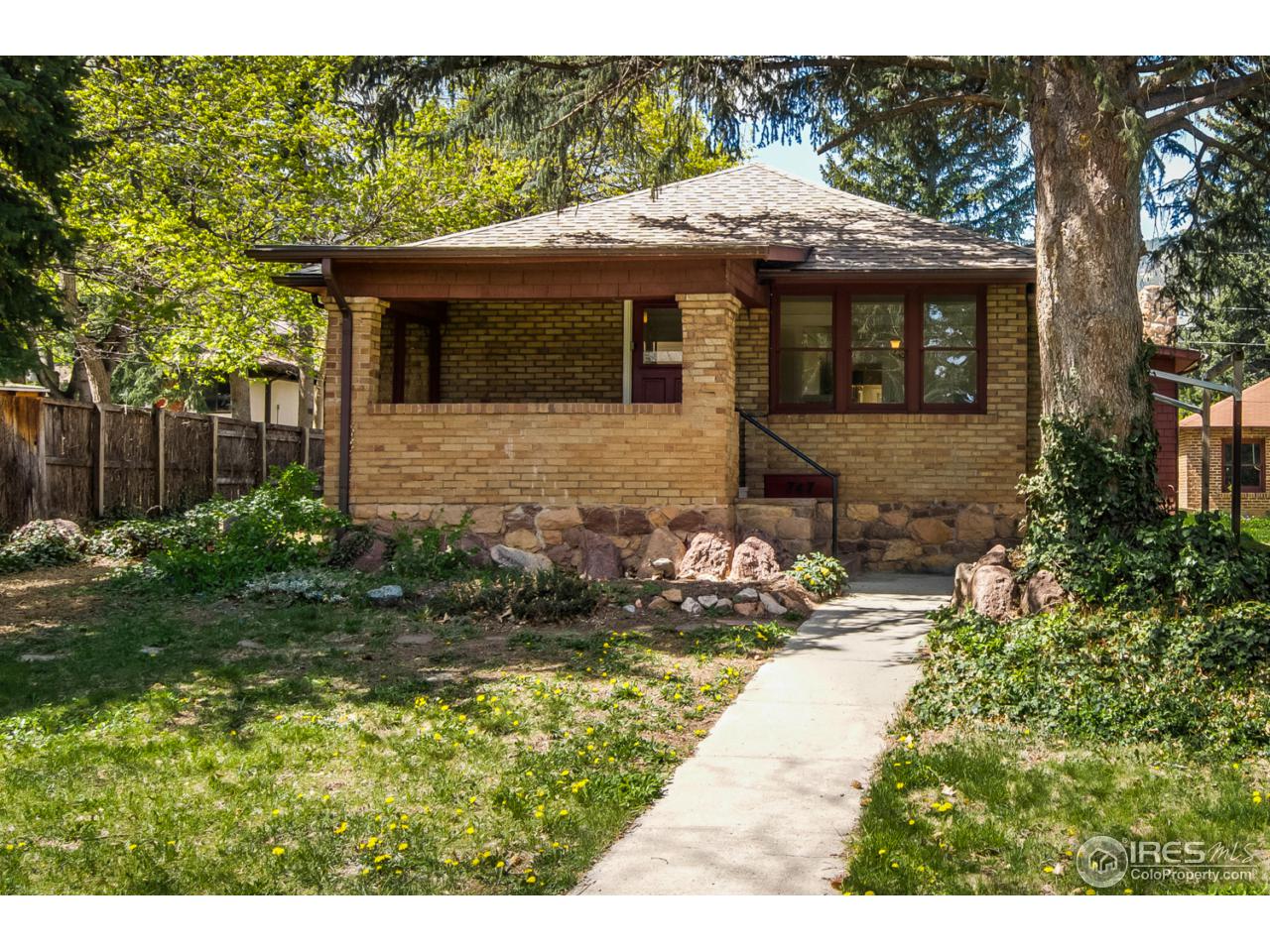 747 12th Street Boulder, CO 80302 - Photo 1 of 25 a front view of a house with a yard