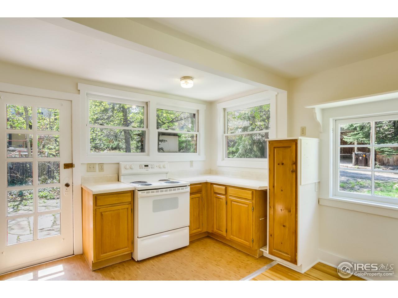 747 12th Street Boulder, CO 80302 - Photo 12 of 25 a kitchen with a stove a refrigerator and a sink