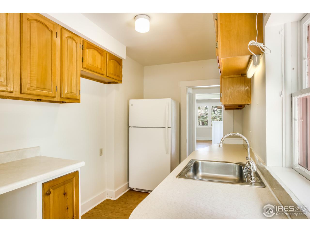 747 12th Street Boulder, CO 80302 - Photo 13 of 25 a kitchen with a sink and a refrigerator