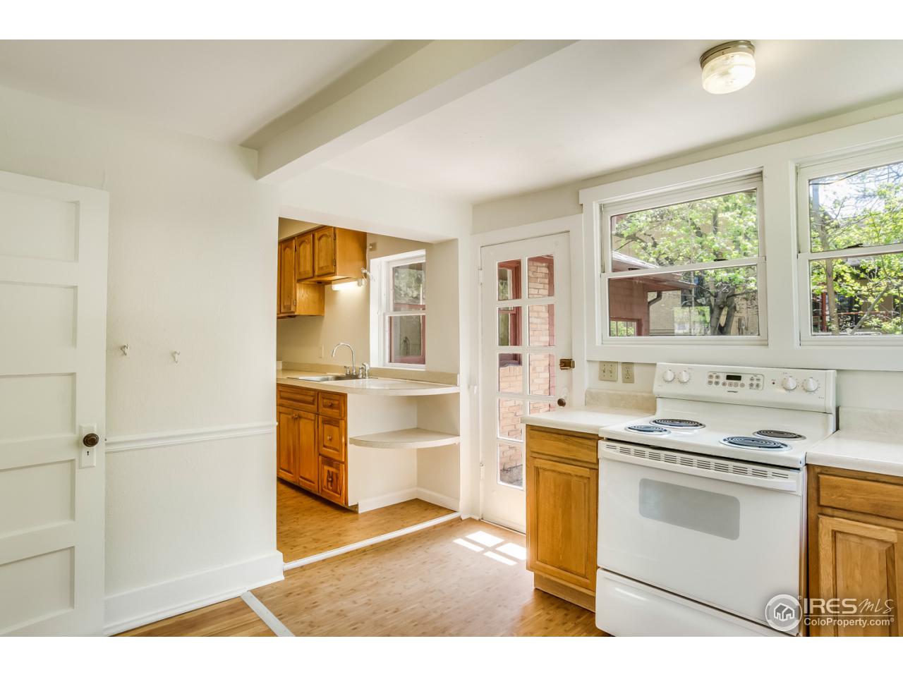 747 12th Street Boulder, CO 80302 - Photo 16 of 25 a kitchen with a stove a sink and a refrigerator