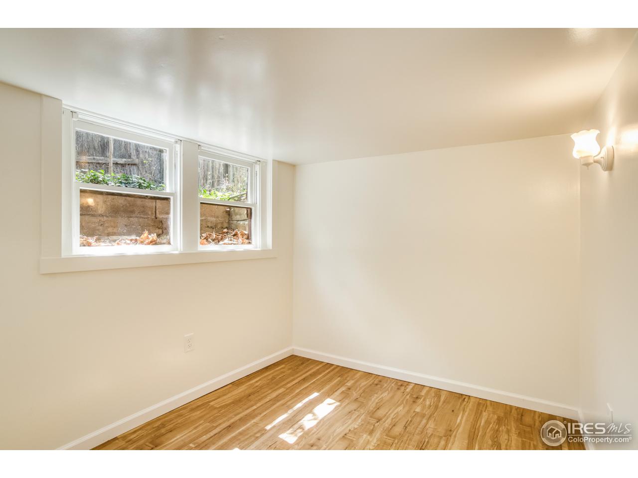 747 12th Street Boulder, CO 80302 - Photo 21 of 25 a view of an empty room with wooden floor and a window