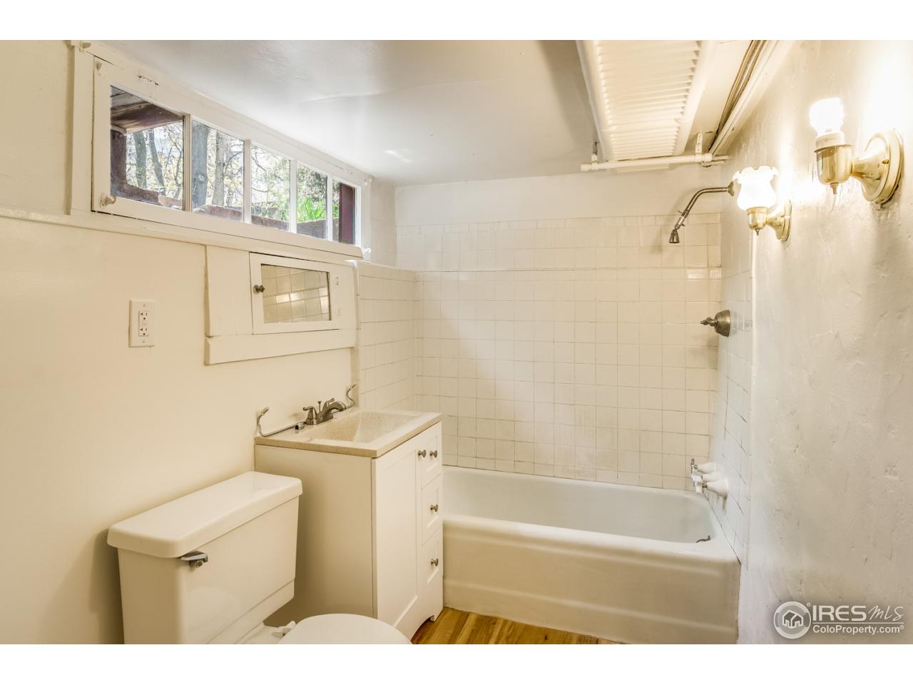 747 12th Street Boulder, CO 80302 - Photo 23 of 25 a bathroom with a sink a toilet and shower