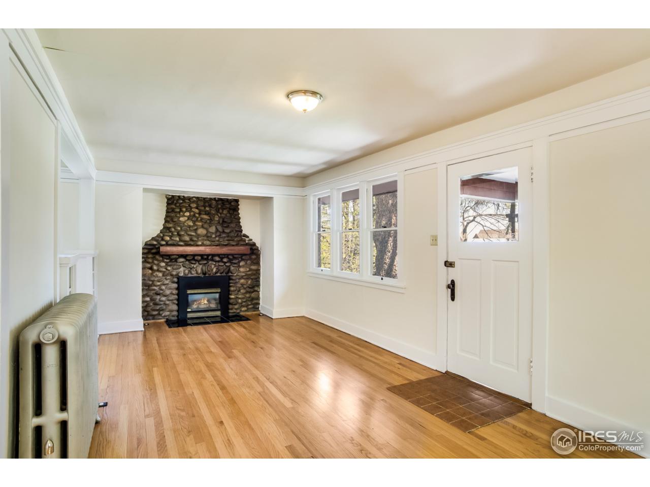 747 12th Street Boulder, CO 80302 - Photo 4 of 25 a view of empty room with window and fireplace