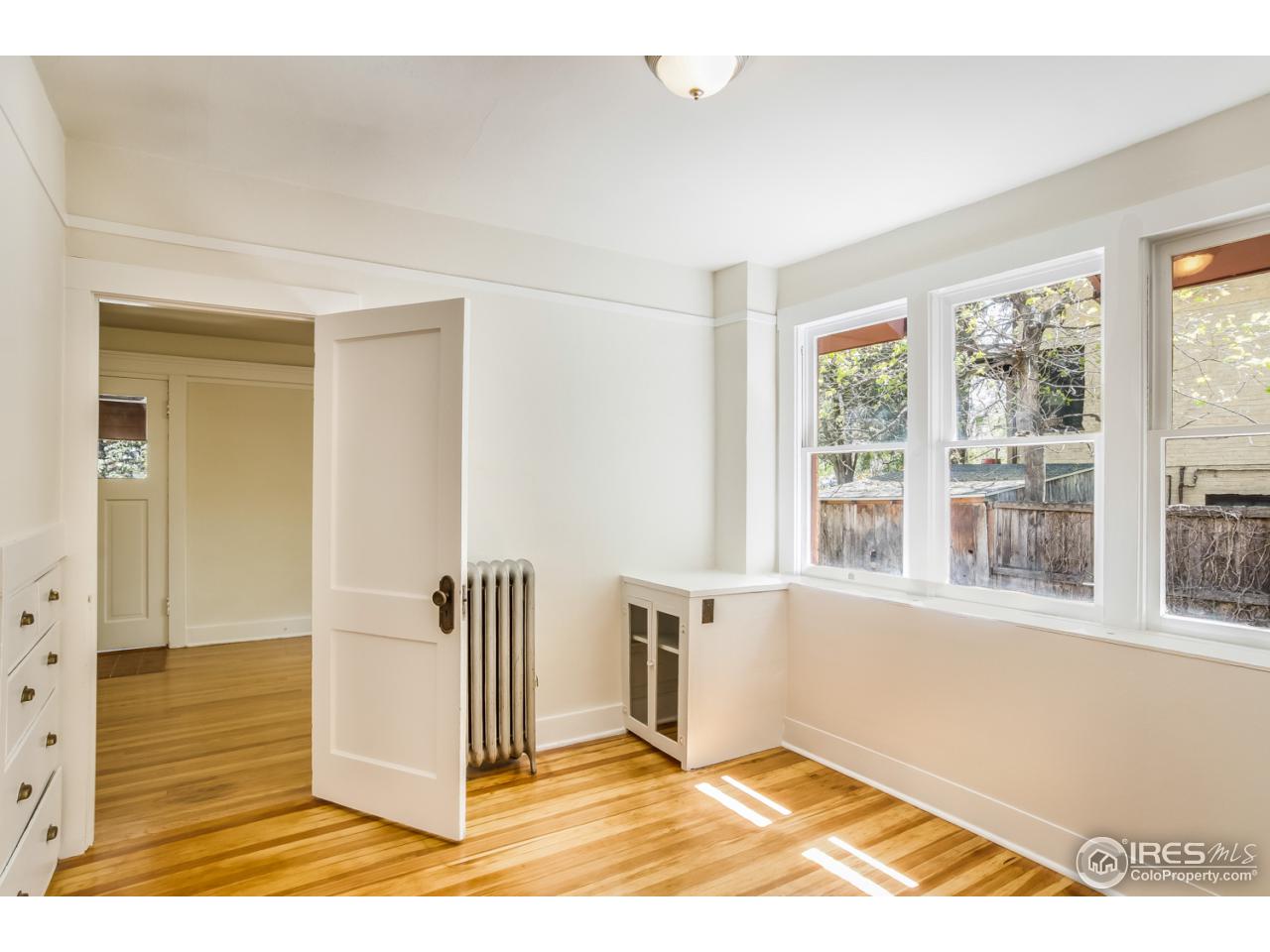 747 12th Street Boulder, CO 80302 - Photo 8 of 25 a view of an empty room with wooden floor and a window