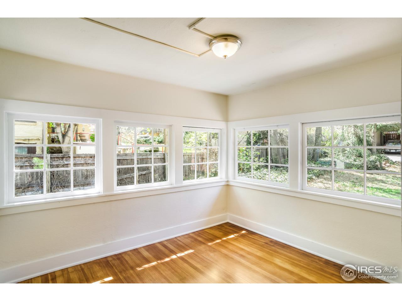 747 12th Street Boulder, CO 80302 - Photo 10 of 25 a view of an empty room with a window and wooden floor