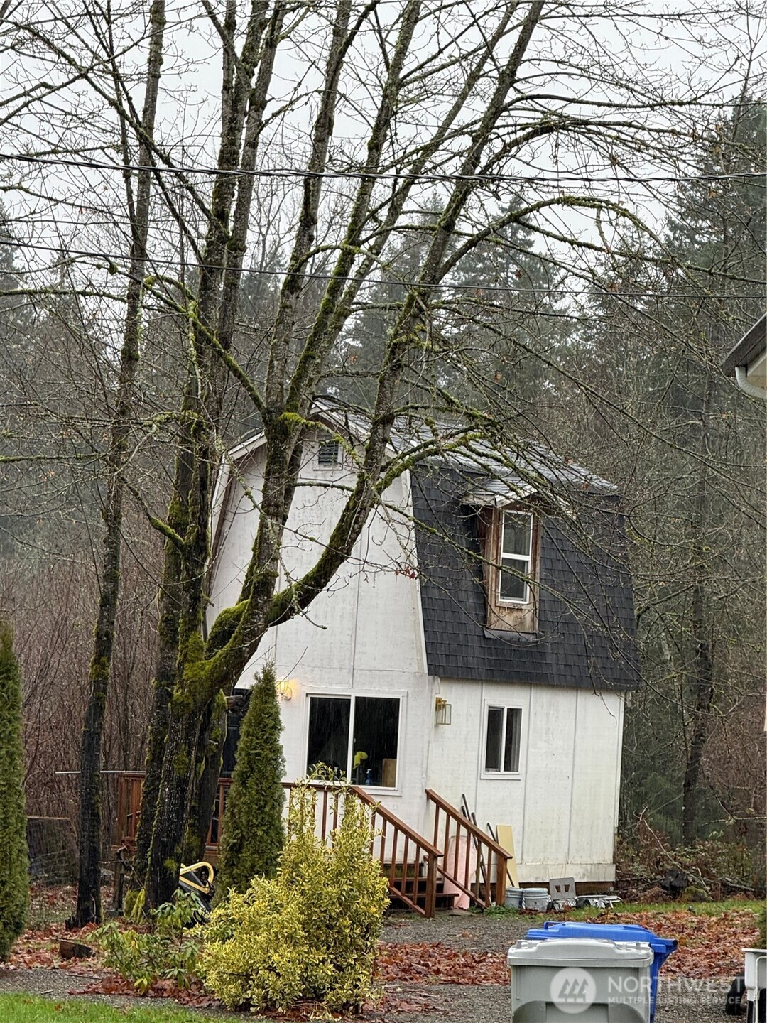 26005 156th Street Southeast Covington, WA 98042 - Photo 6 of 24 a view of a white house with large trees
