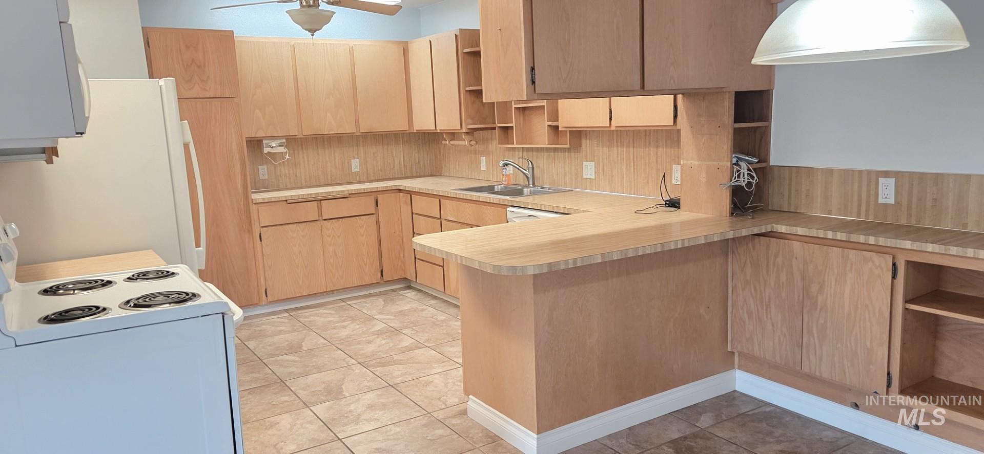 1902 Arlington Street Pomeroy, WA 99347 - Photo 17 of 27 Kitchen with open shelves, white appliances, a peninsula, light countertops, and light tile patterned floors