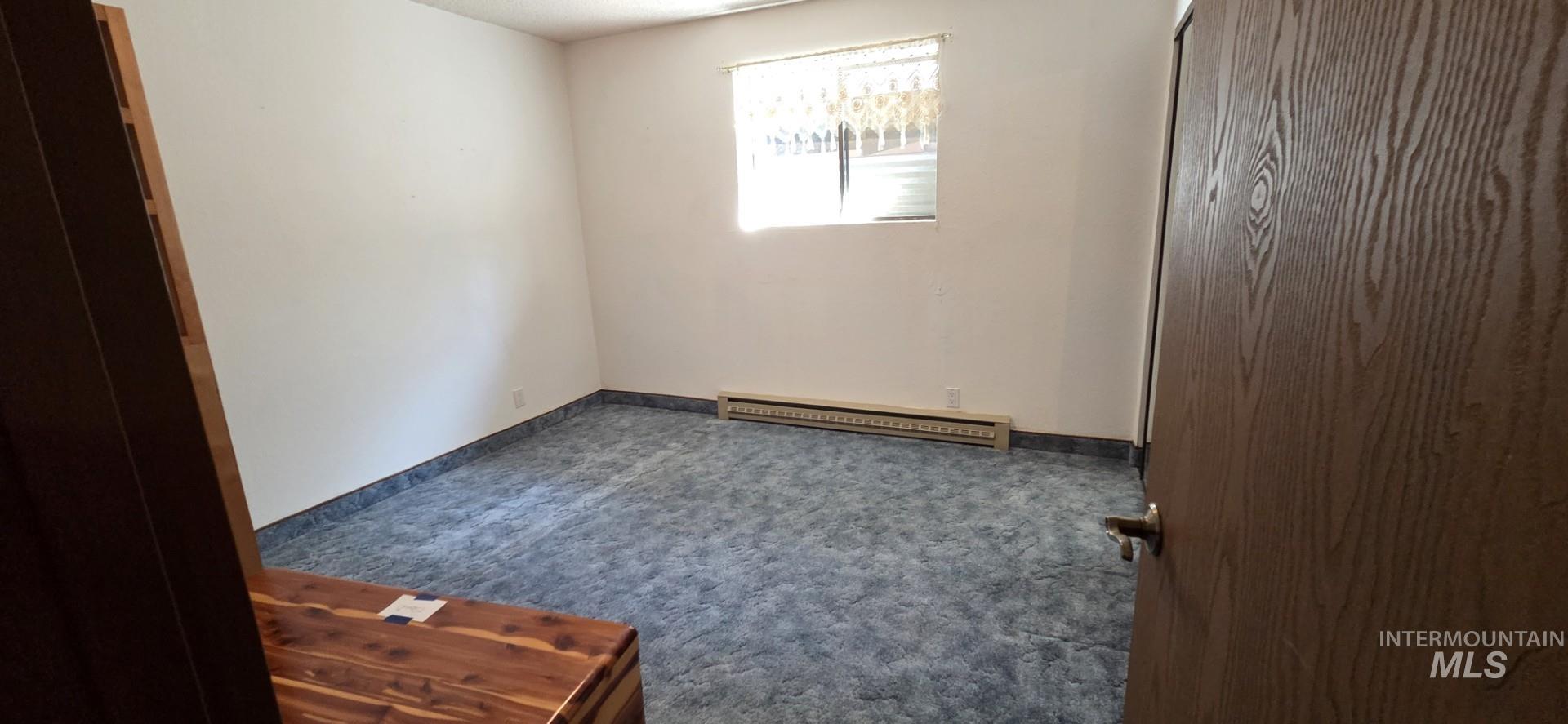 1902 Arlington Street Pomeroy, WA 99347 - Photo 25 of 27 Unfurnished bedroom with carpet and baseboard heating