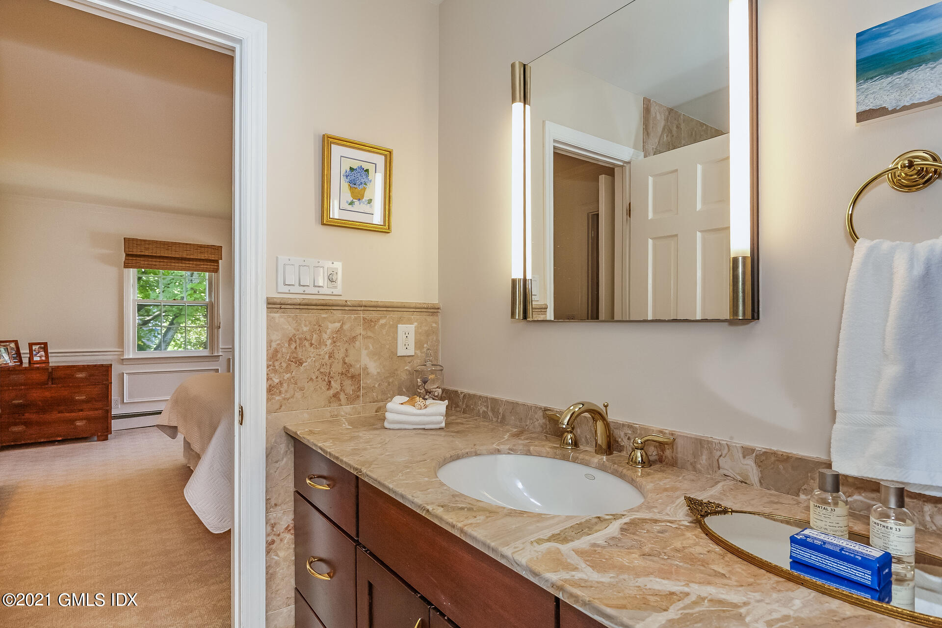 27 Perryridge Road Greenwich, CT 06830 - Photo 13 of 24 a en suite bathroom with a granite countertop sink and a mirror