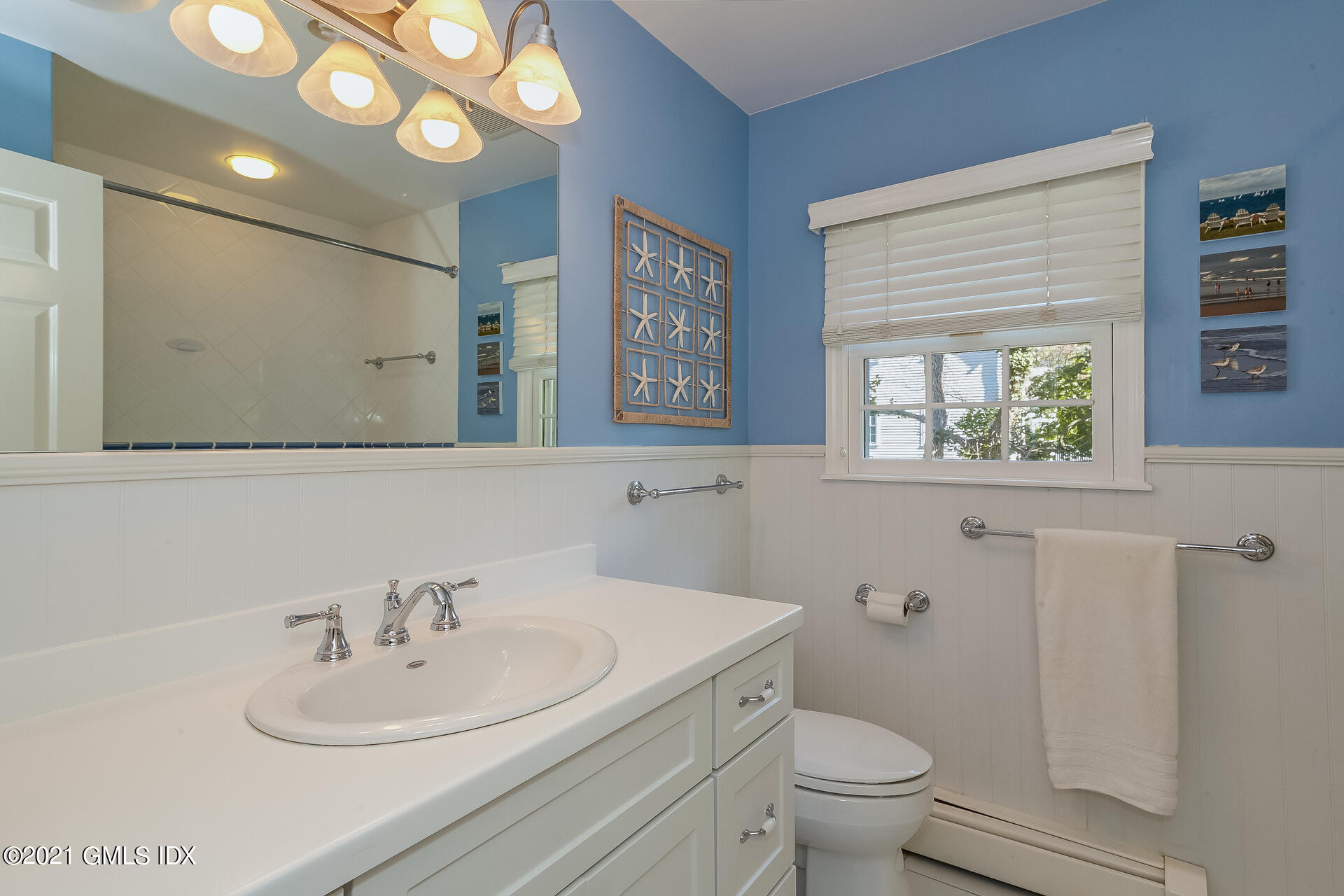 27 Perryridge Road Greenwich, CT 06830 - Photo 17 of 24 a bathroom with a sink a toilet and a mirror