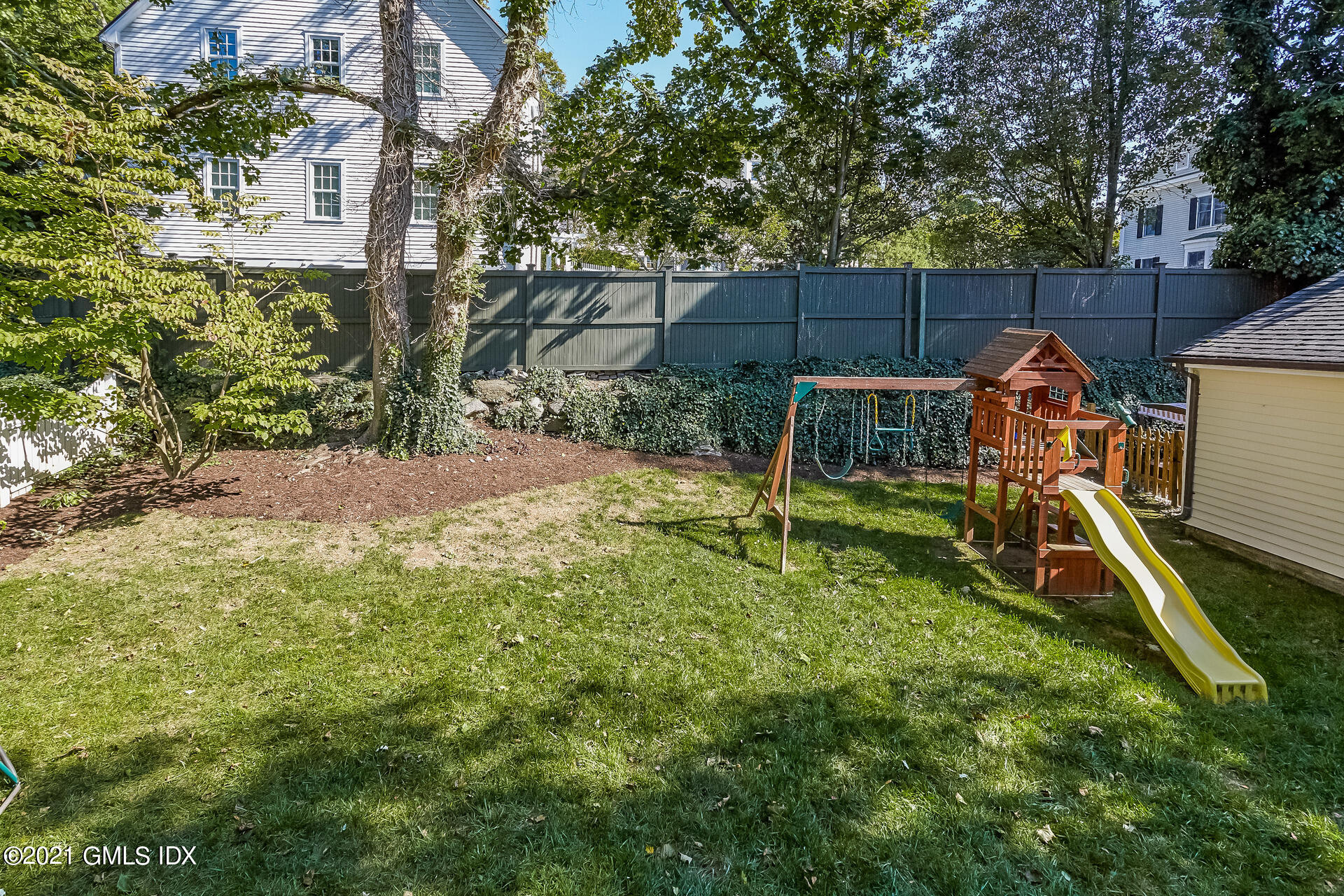 27 Perryridge Road Greenwich, CT 06830 - Photo 21 of 24 a view of a backyard with a slide