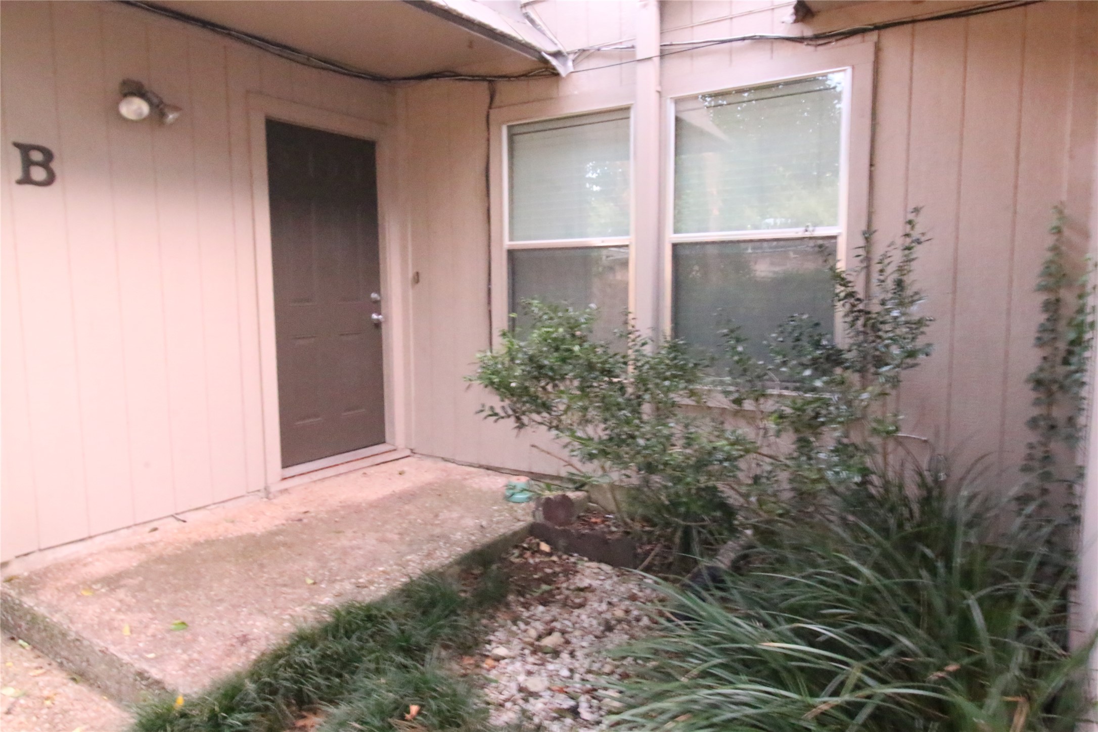 703 Castle Ridge Road, Unit B Austin, TX 78746 - Photo 2 of 5 A welcoming entry with lush landscaping adds natural appeal to this residence.