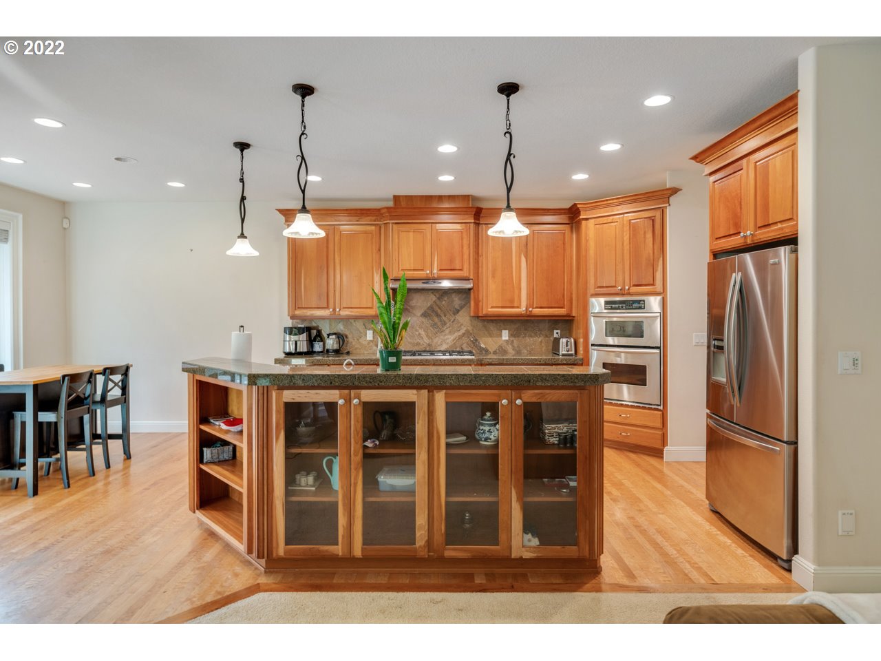 1311 South 6th Way Ridgefield, WA 98642 - Photo 8 of 31 a kitchen with stainless steel appliances granite countertop a refrigerator a oven a sink and a dining table