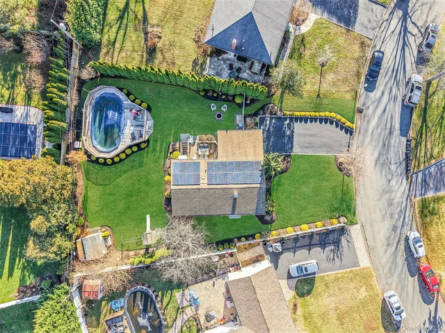 an aerial view of a house with swimming pool patio and outdoor seating