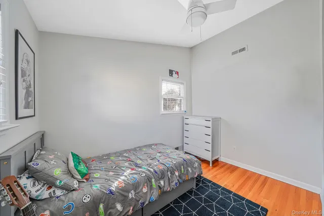 a bed sitting in a bedroom next to a window