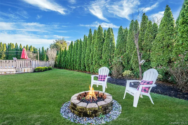 a backyard of a house with table and chairs