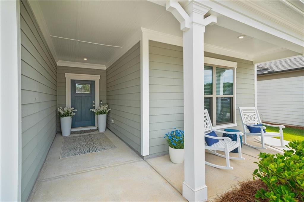 2457 Naples Street Hoschton, GA 30548 - Photo 33 of 41 a view of a patio with table and chairs and potted plants
