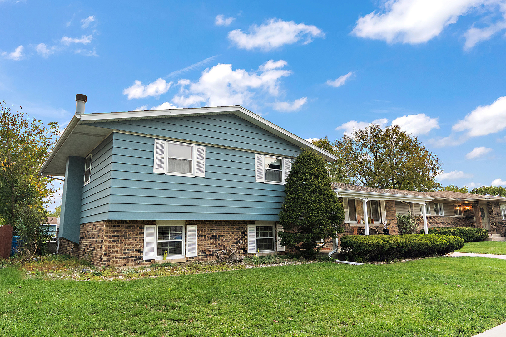 2924 192nd Place Lansing, IL 60438 - Photo 2 of 33 a front view of a house with a garden and plants