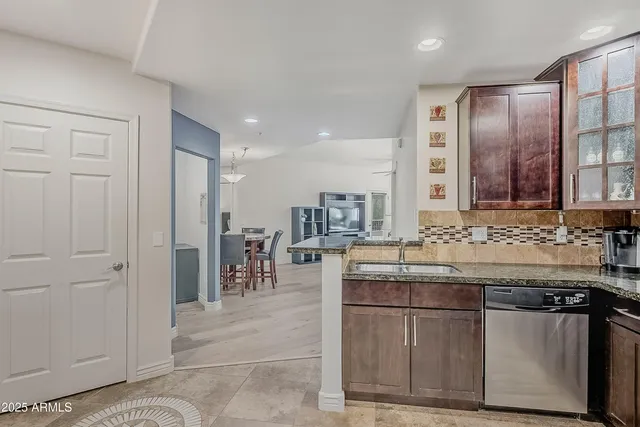 a kitchen with stainless steel appliances granite countertop a sink and cabinets