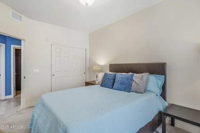 a bedroom with a bed and a night stand