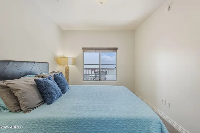 a spacious bedroom with a bed and a window