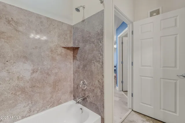 a bathroom with a bathtub and shower