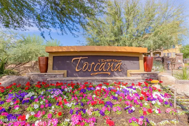 a street sign that is in front of flowers