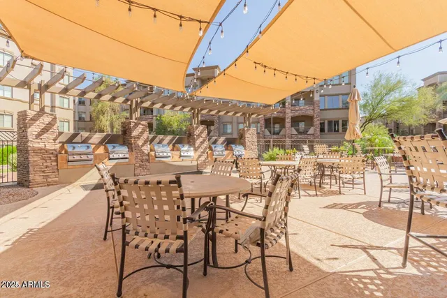 a view of a chairs and table in backyard