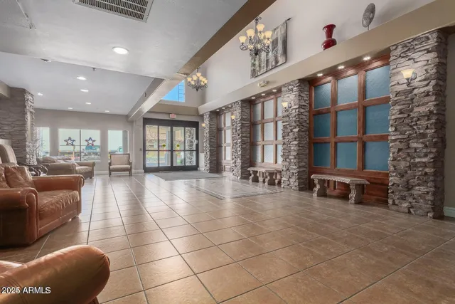 a lobby with furniture and large windows