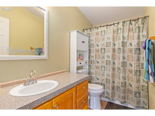 310 Pitney Lane, Unit 40 Junction City, OR 97448 - Photo 20 of 36 a bathroom with a sink toilet and shower